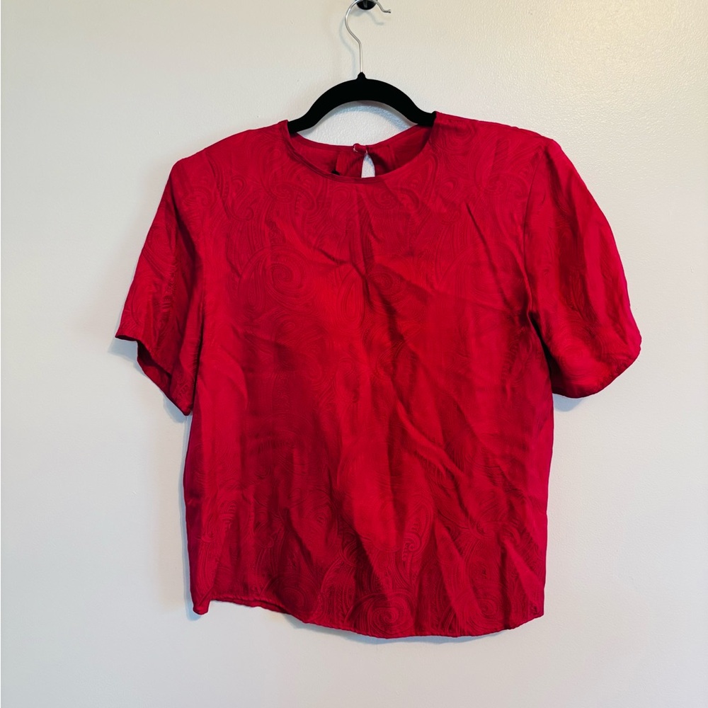 Vintage 80’s silk short sleeve blouse with shoulder pads. Size medium.